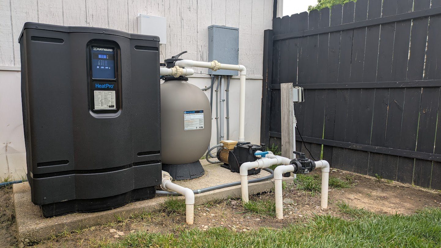 Hayward HeatPro pool heater, sand filter, and pump wired on a backyard equipment pad by Benrishi Electrical